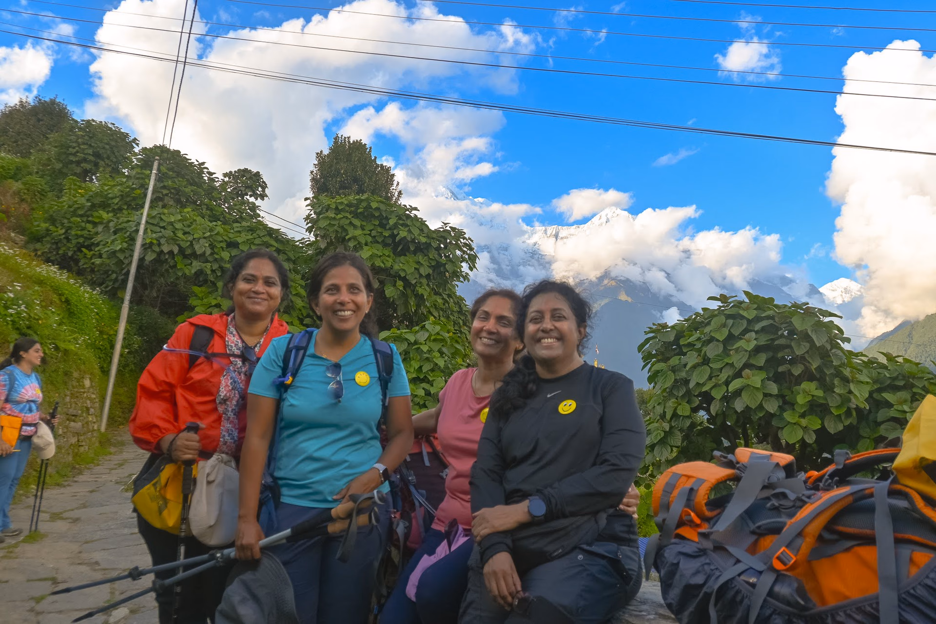 Trekkers walking across a ridge under soft evening light